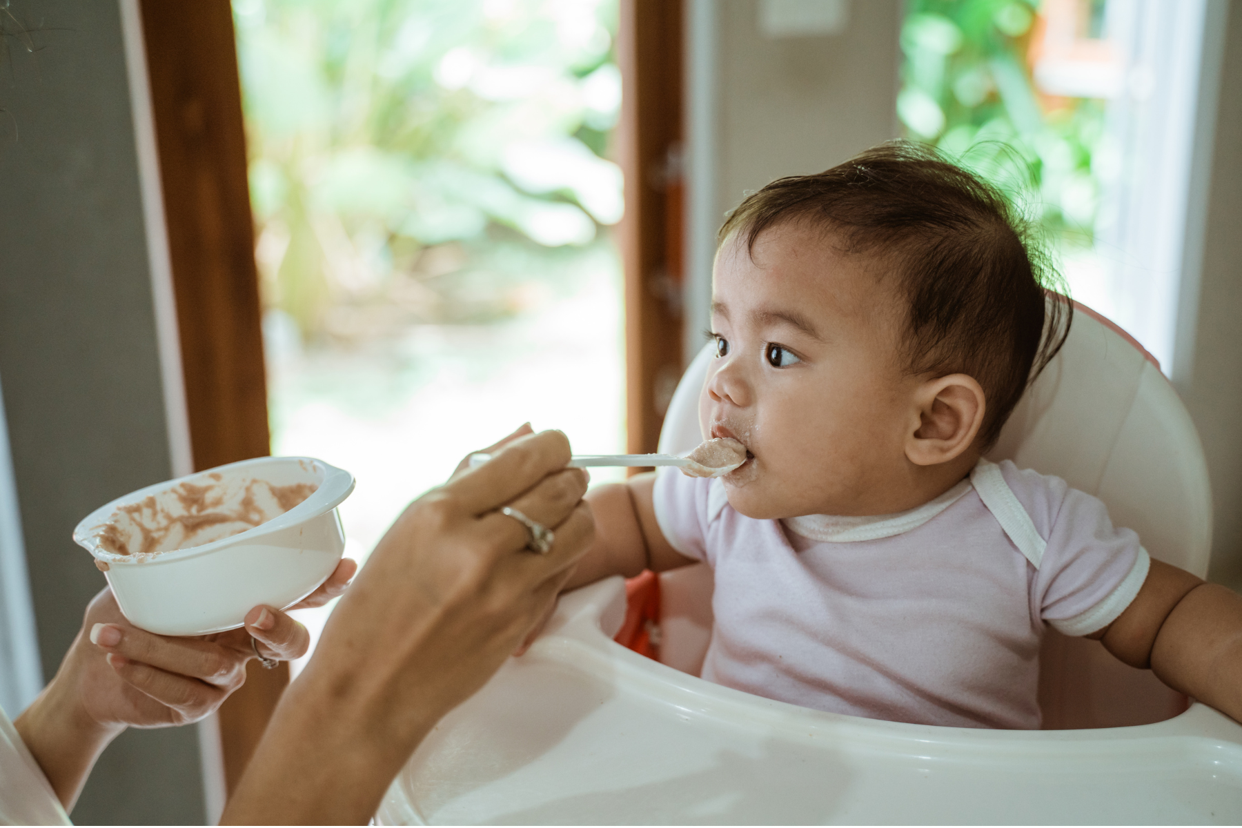 Baby enjoying first foods